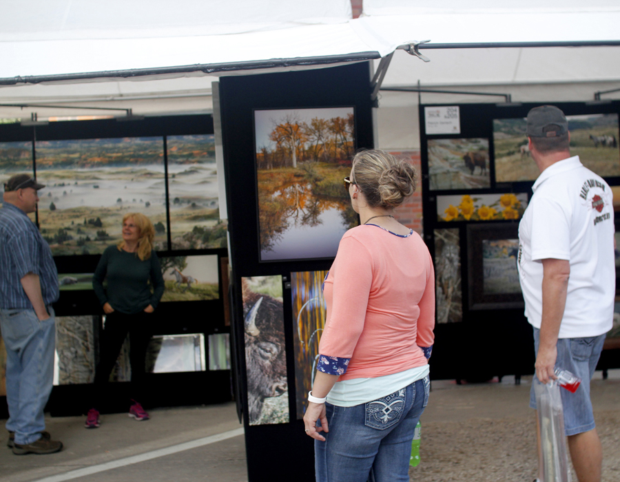 SWAF attendees browsing an art booth