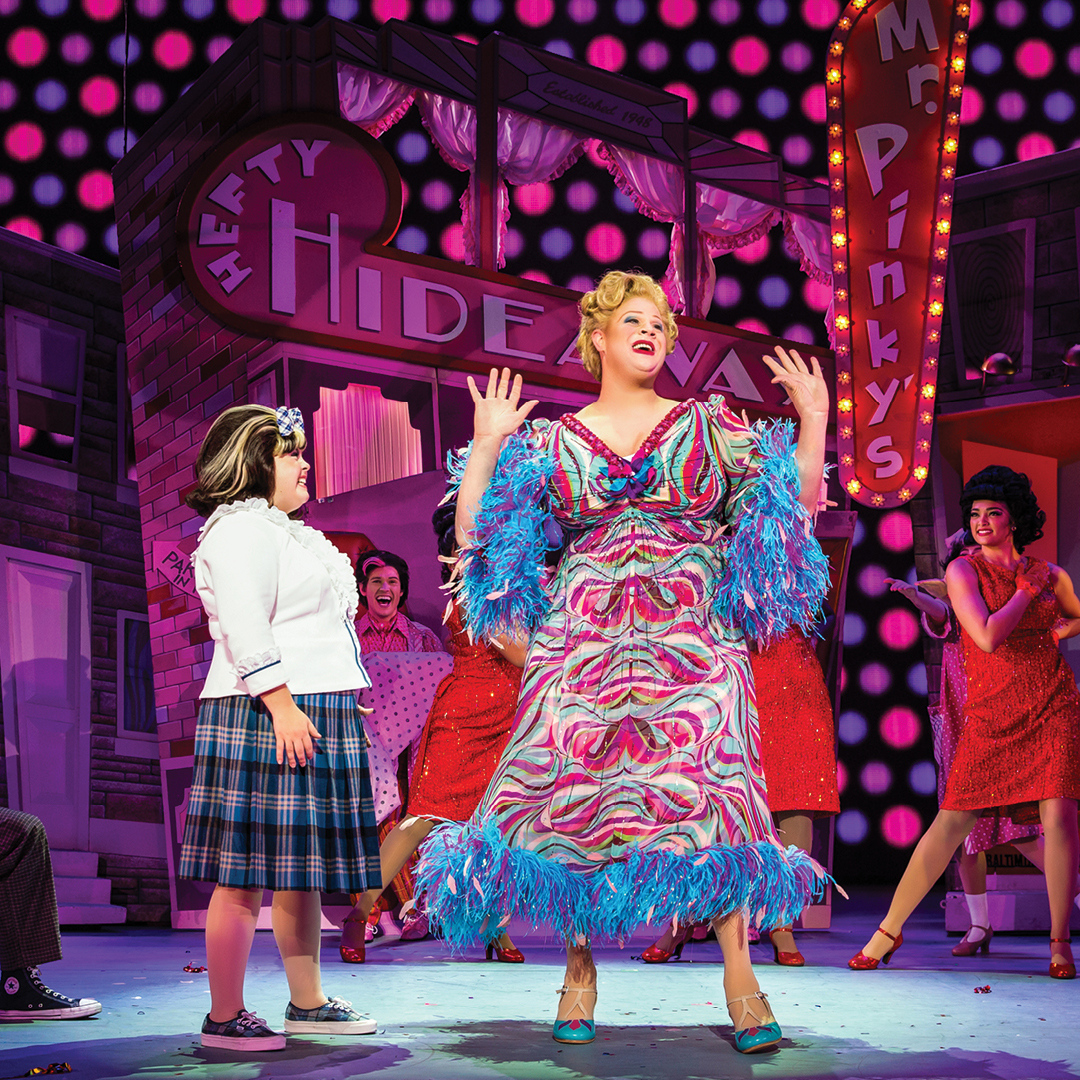02	“Welcome to the 60s” - (from L) Niki Metcalf as “Tracy Turnblad,” Andrew Levitt (aka Nina West) as “Edna Turnblad” and company in Hairspray.  Photo: Jeremy Daniel.