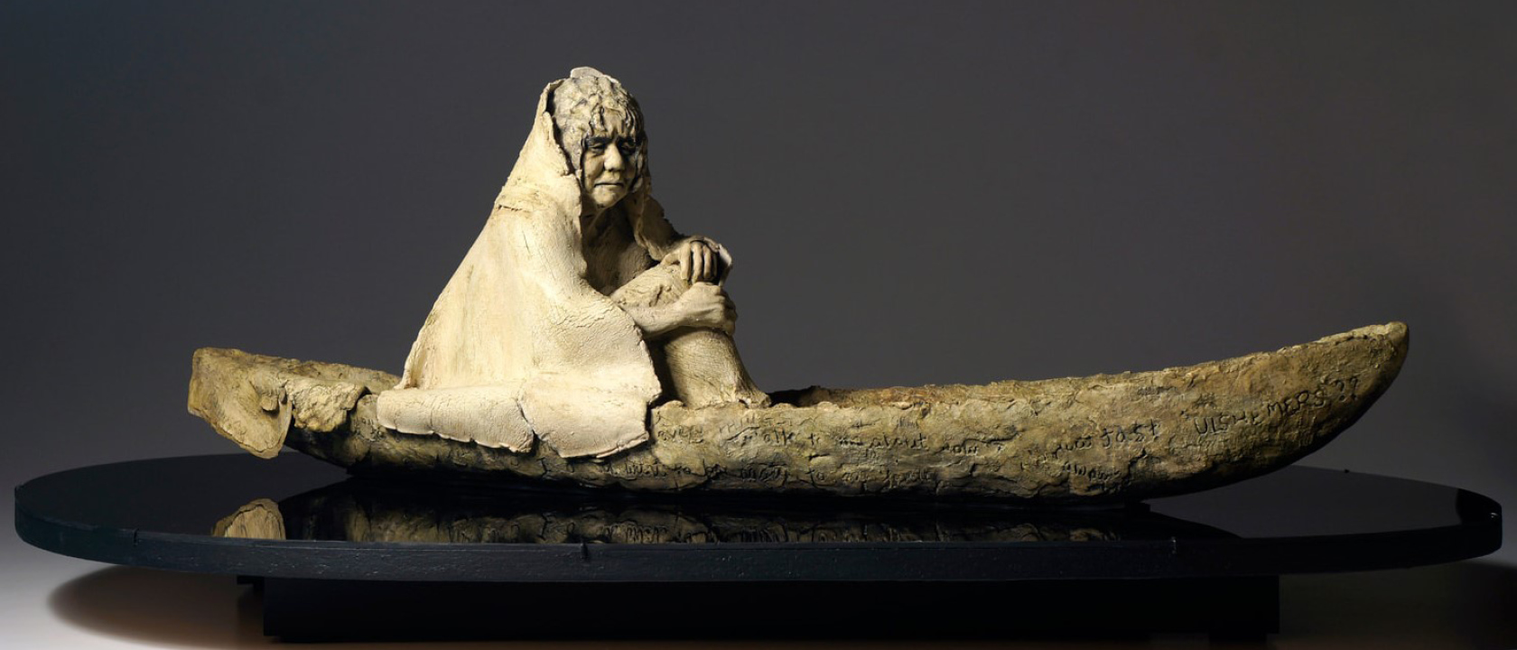 sculpture of person in boat
