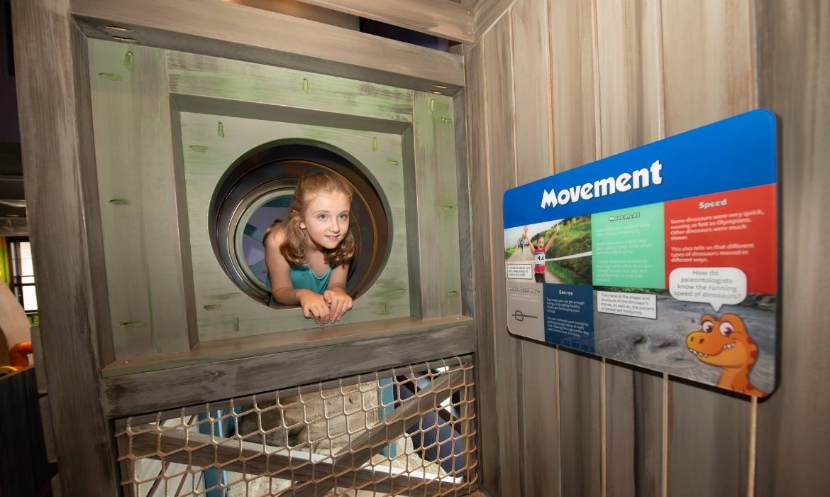 Girl Playing on Prehistoric Adventure Climber