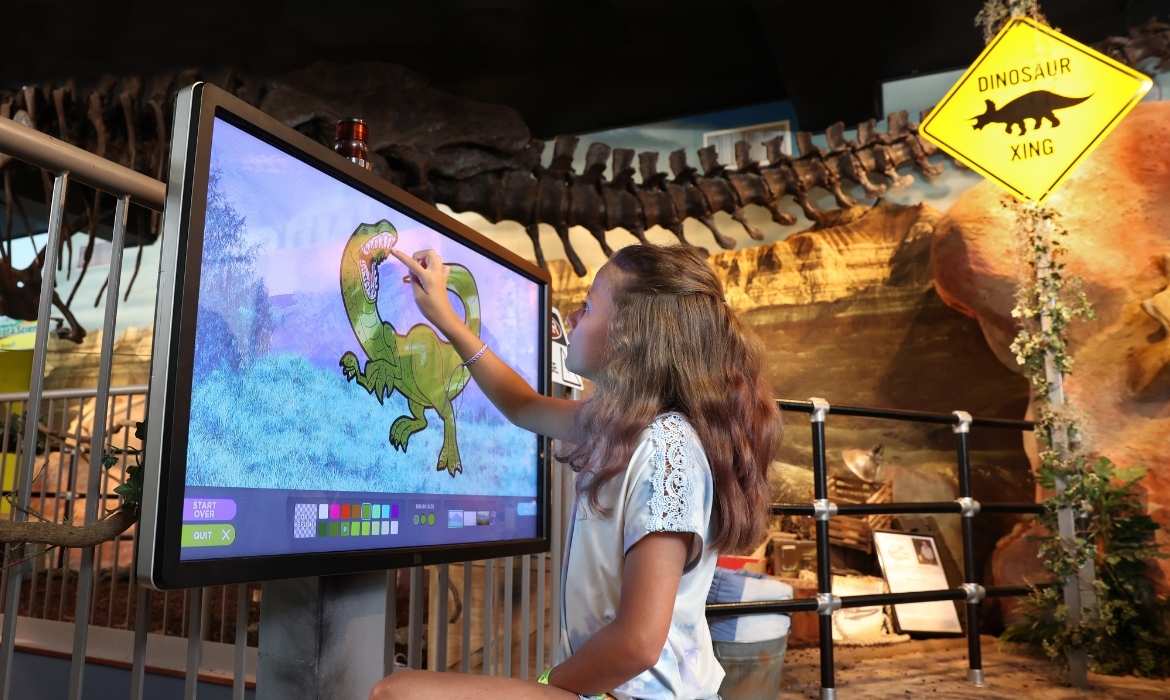 Girl Coloring at Dinosaur Discovery